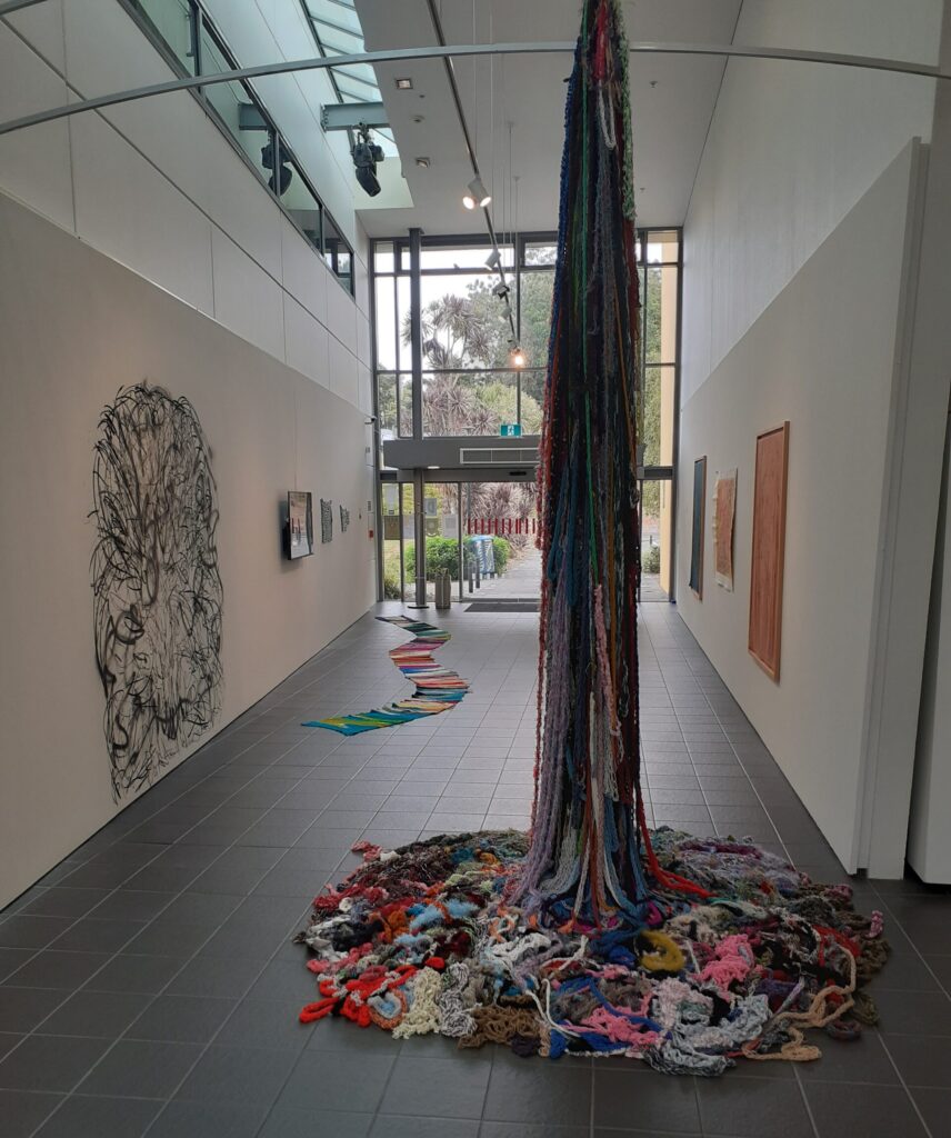 An installation artwork by Wesley Fourie. A knitted representation of South Africa's tallest mountain. Bundles of wool lay in a circle at the base and in the centre are pulled up dramatically to the ceiling.