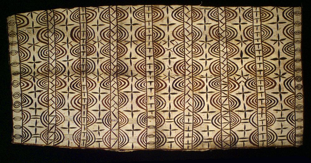 Decorated cloth from Niue, with circle and star motifs and regular vertical lines.