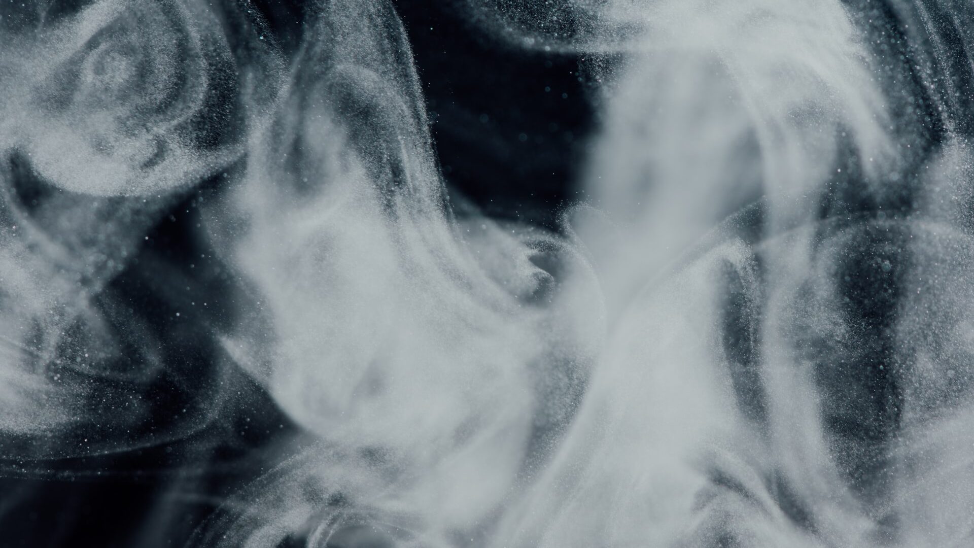 Translucent white smoke across a black background.